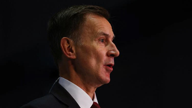 UK's Hunt tries to defuse tax row with cuts to government staff
