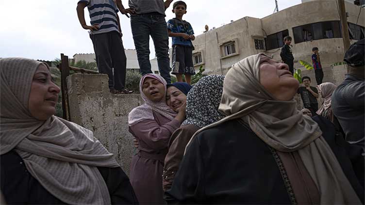 Palestinians rush to buy food and struggle under strikes as Israel readies possible ground operation