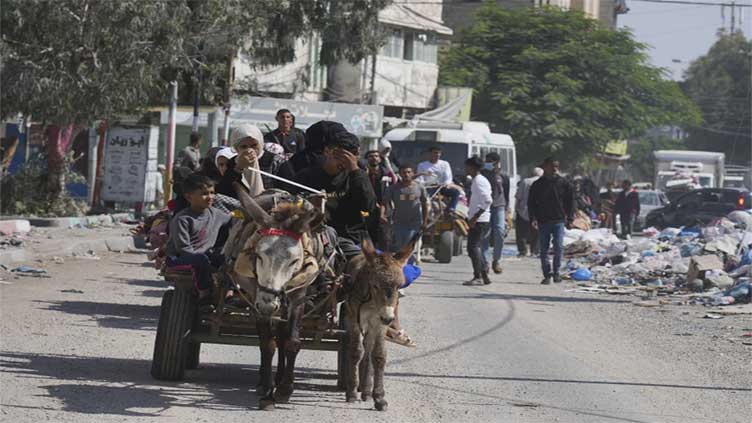 Gaza's desperate civilians flee or huddle in hopes of safety, as warnings of Israeli offensive mount