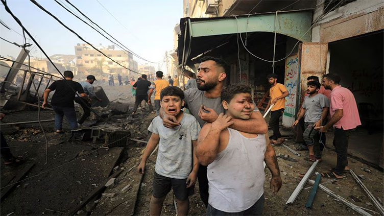 Israel bombards Gaza, prepares invasion as Putin warns conflict could spread beyond Middle East