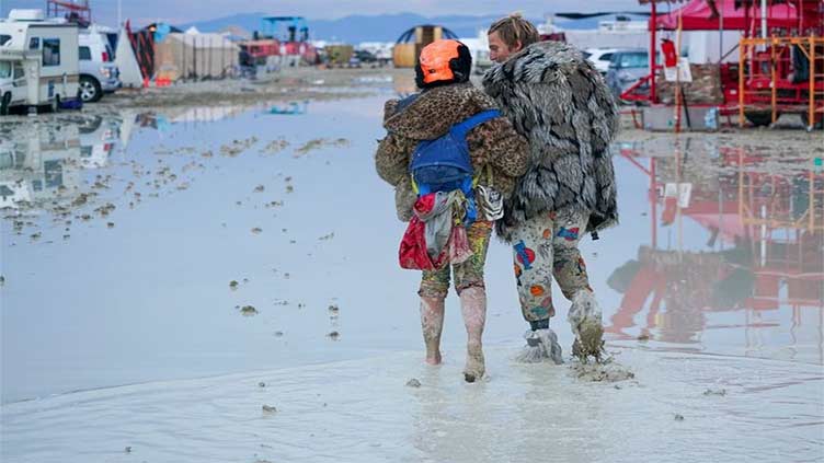 Burning Man revelers unfazed by deluge and deep mud