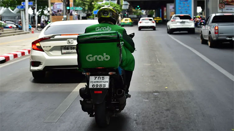 Thailand's food delivery drivers feel pinch as Grab, Line rack up losses