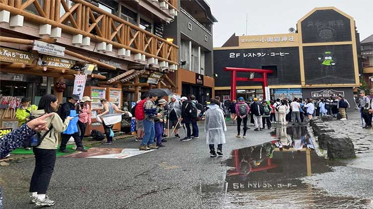 Japan says swarms of tourists defiling sacred Mt Fuji