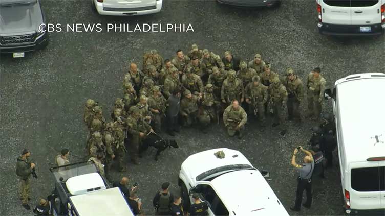 After catching escaped murderer, officers took a photo with him. Experts say that was inappropriate