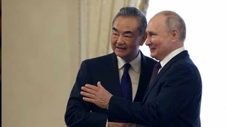 China ready to continue business cooperation with Russia, top diplomat tells Putin