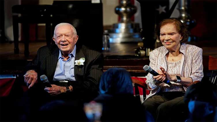 Former US President Jimmy Carter rides through Georgia peanut fest