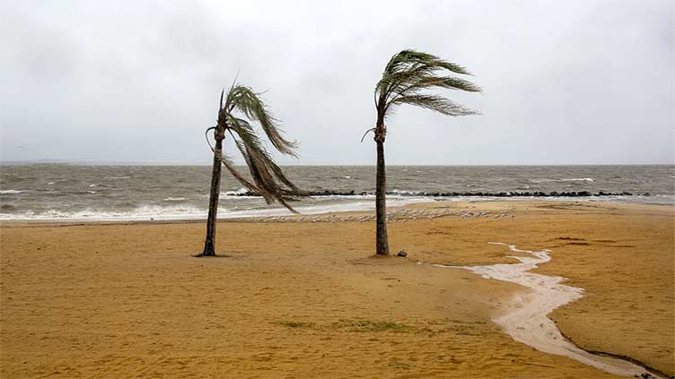 Weakening Ophelia still poses a risk of coastal flooding and heavy rain in some parts of the US