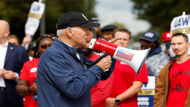 Biden says UAW should fight for 40pc pay raise in Michigan strike visit