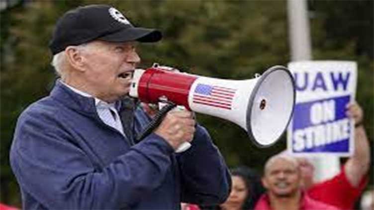 Biden urges striking auto workers to 'stick with it' in picket line visit unparalleled in history