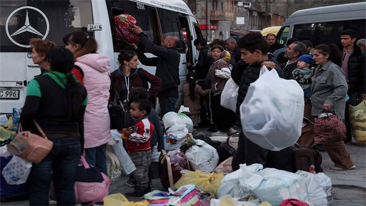 Karabakh refugees burn cherished possessions on way out