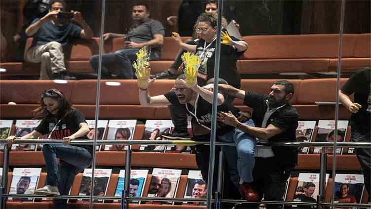 Protesters seeking hostages' release smear paint in Israeli parliament