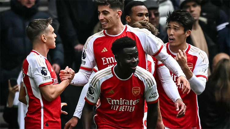 Arsenal survive Spurs fightback to boost title charge