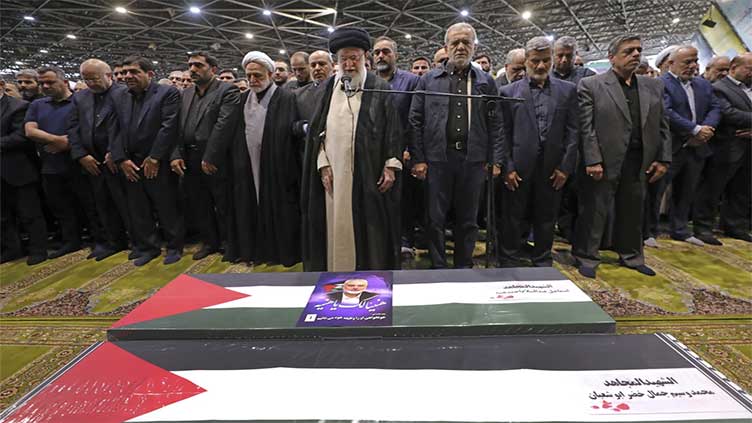 Iran's supreme leader prays over the coffin of Hamas leader Haniyeh, whose killing risks a wider war