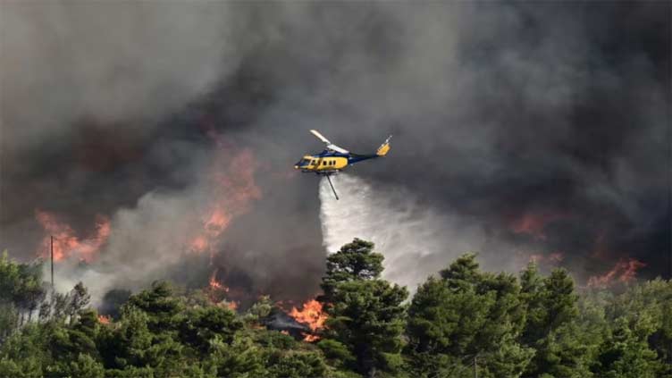 Residents flee as wildfire rages uncontrolled near Athens