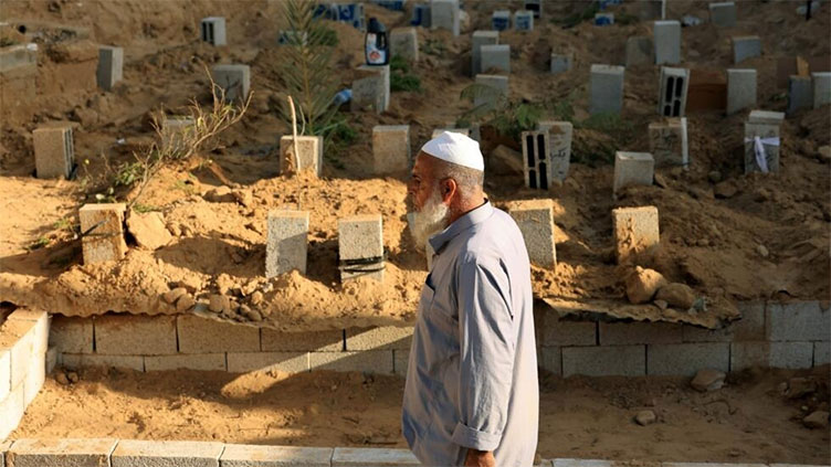 Gaza's overwhelmed undertakers stack 'graves on top of graves'