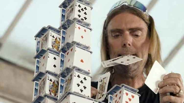 Ace architect breaks world record with 54-level house of cards in 8 hours