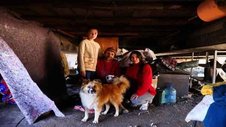 Brazilian family left homeless by floods finds refuge under road bridge