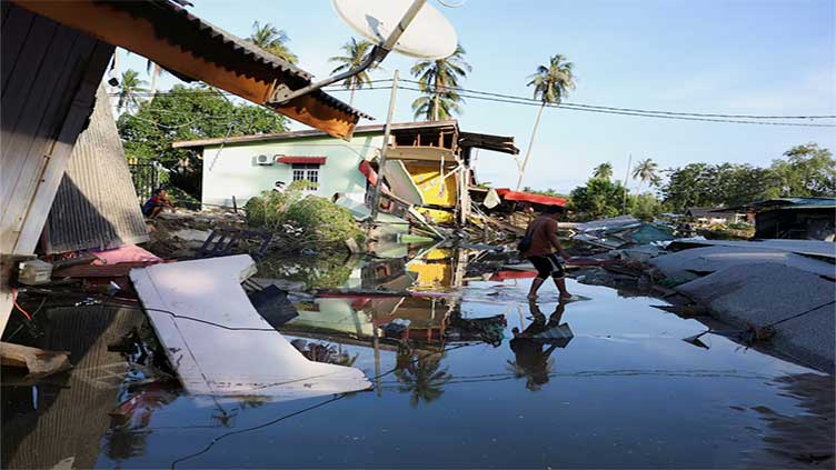 Clean-up begins in Malaysia towns hit by six months of rain in five days