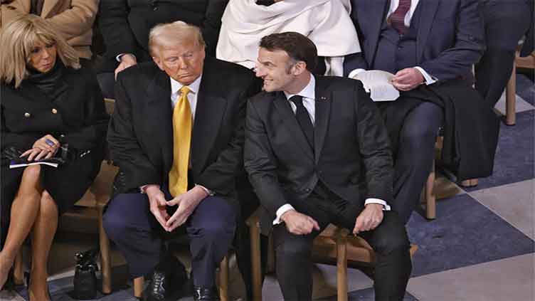 An archbishop's knock formally restores Notre Dame to life as winds howl and heads of state look onPARIS