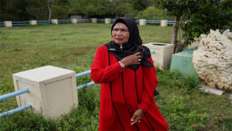 Indonesian tsunami survivor holds on to hope for missing son after 20 years