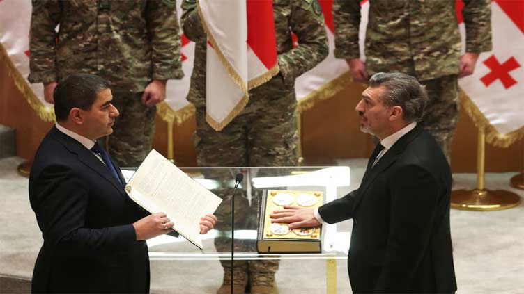 New Georgian president sworn in; predecessor says he is not legitimate leader