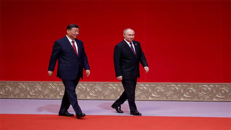 China, Russia always moving forward 'hand in hand', Xi tells Putin