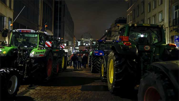 Farmers on tractors create chaos outside an EU summit to protest rising costs and bureaucracy