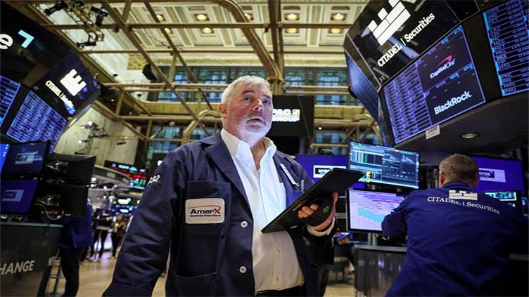Stock market today: Wall Street hangs near its record high as the bond market calms