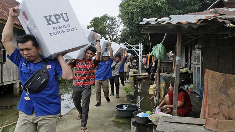 Election ballots and boxes carried across Indonesia by motorcycle, boat, horse and on foot