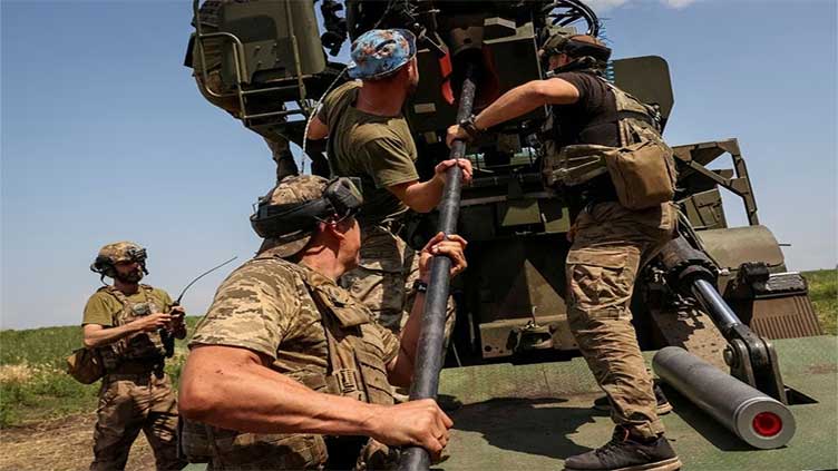Ukrainian troops pull back again as Russia's onslaught pushes ahead in eastern Ukraine