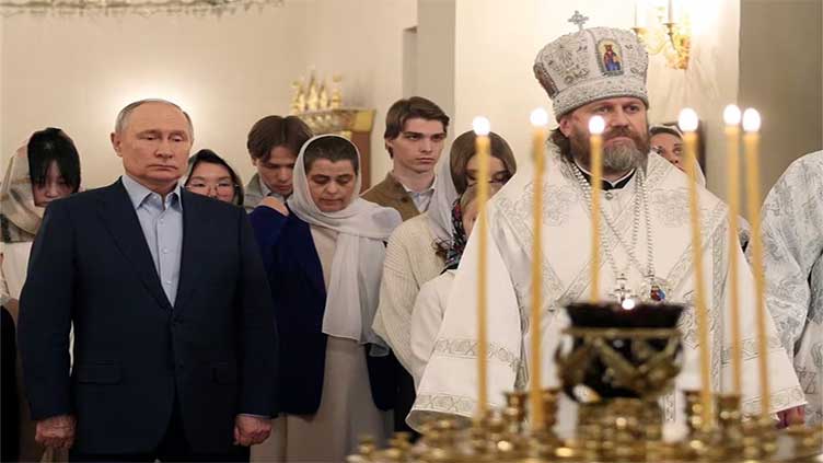 On Orthodox Christmas Putin vows to back soldiers who 'defend' Russia