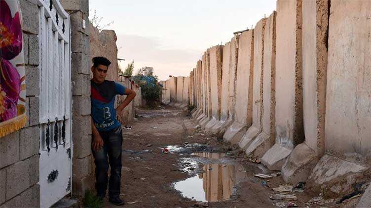 Years after civil war, security wall holds back Iraqi city