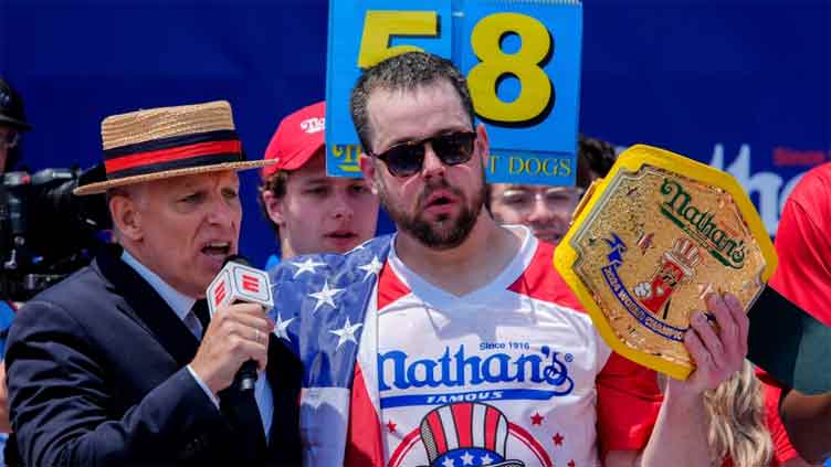 Who wins top dog honors at Famous power-eating contest