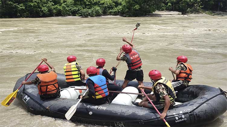 Rescuers in Nepal recover 11 bodies after a landslide swept 2 buses full of people into a river