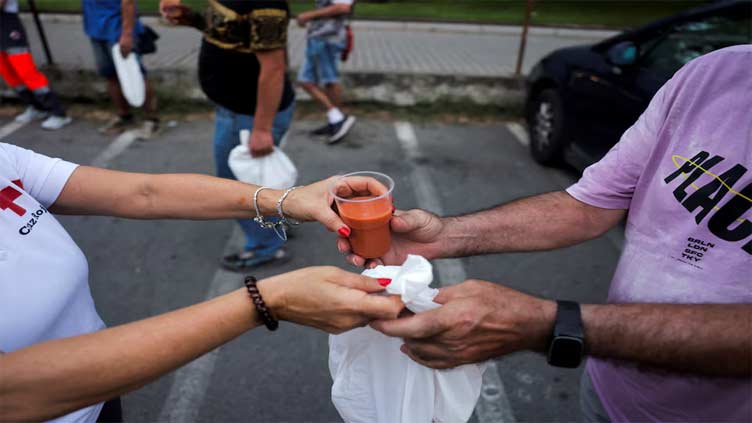 As Spain swelters, volunteers serve cold soup to homeless