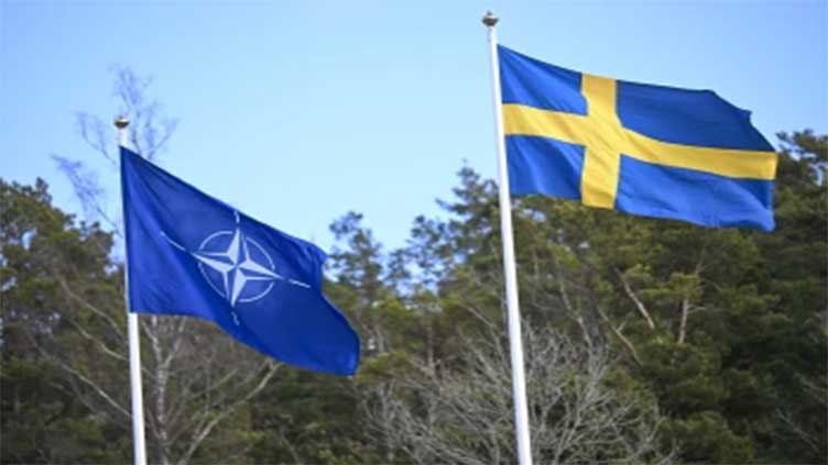 Sweden's flag is raised at NATO headquarters to cement its place as the 32nd member of the alliance