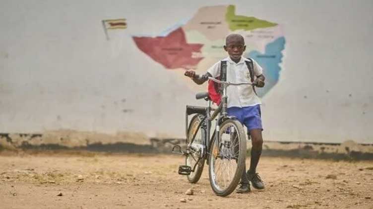 Zimbabwean schoolkids cycle past elephant danger