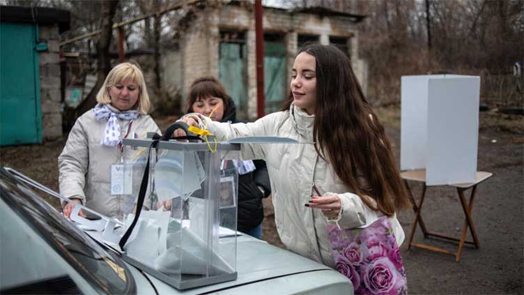 Polls open in Russian presidential election as Ukraine launches border attacks