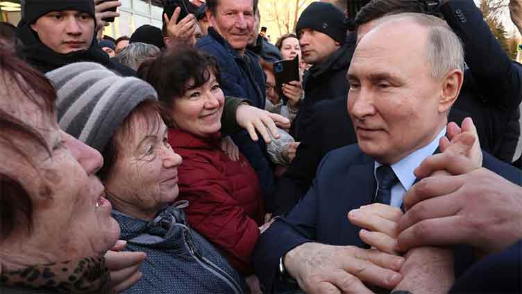 Initial election result shows Vladimir Putin scores landslide victory