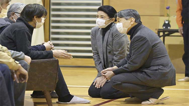 Japanese emperor and empress visit towns hit by Jan 1 quake and console thousands of homeless