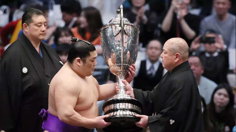 Rookie makes sumo history after winning top tournament