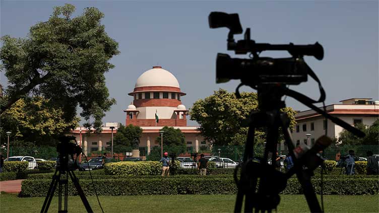India's top court orders release of journalist held in illegal funding case