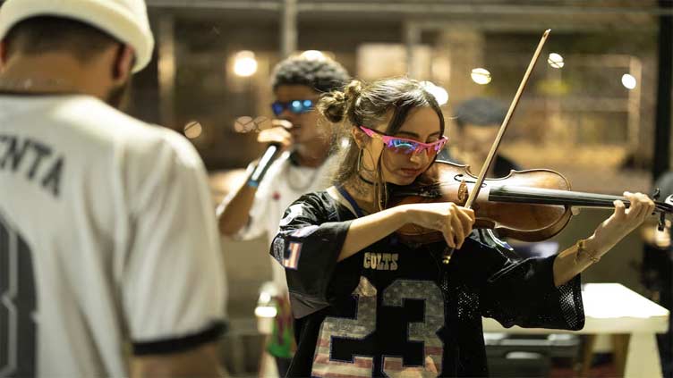 Rap-battling street violinist breaks boundaries in Brazil