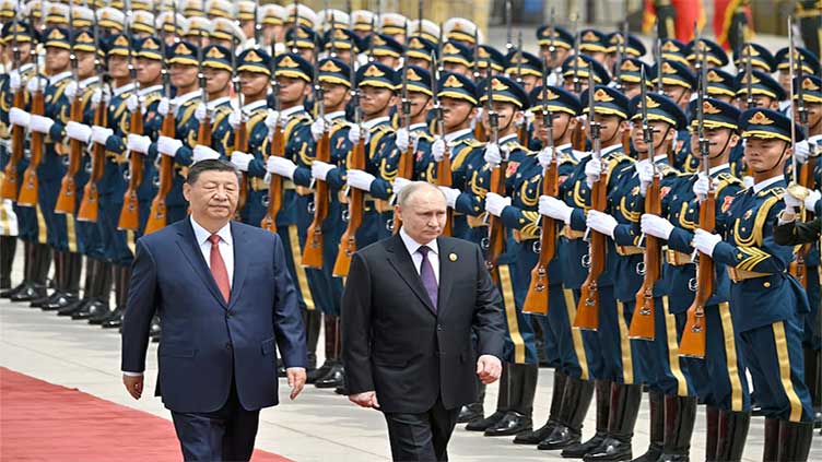 Xi lauds China-Russia ties as Putin lands in Beijing