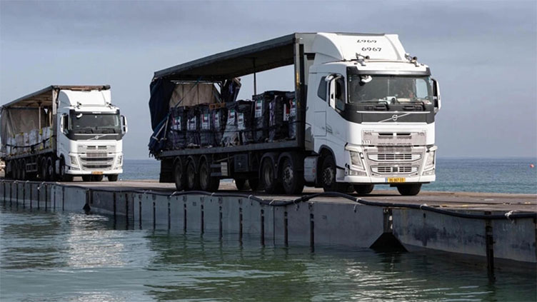 Aid trucks roll across US military-built pier to Gaza for first time