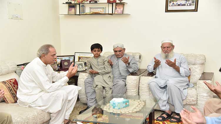 President visits family of martyred Major Babar, offers Fateha