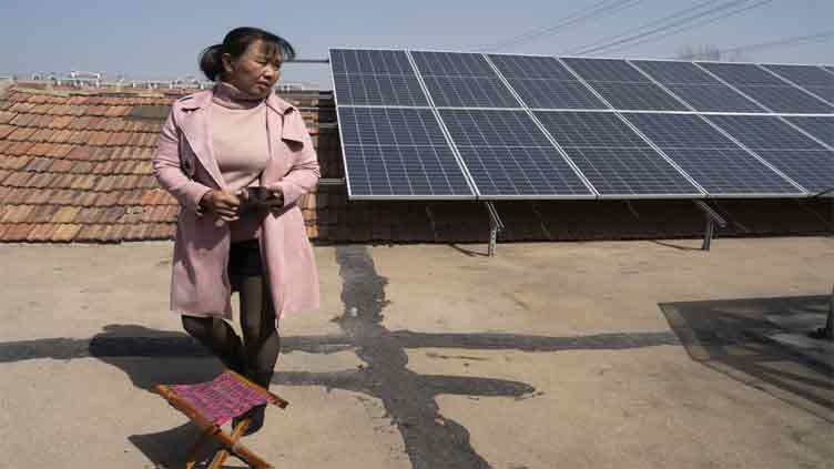 Corn, millet and rooftop solar. China farm family's newest crop