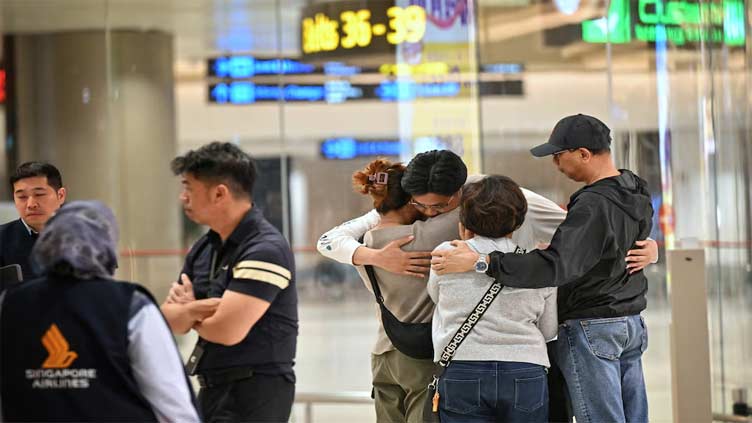 Shaken passengers arrive in Singapore after deadly flight