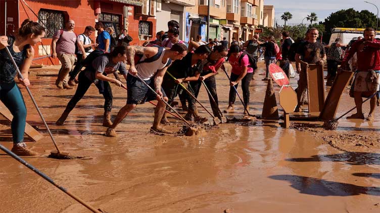 Volunteers bring ray of light to Spanish towns shattered by floods