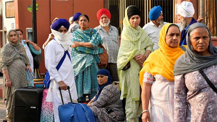 Indian Sikh pilgrims leave after attending Guru Nanak's birthday celebrations